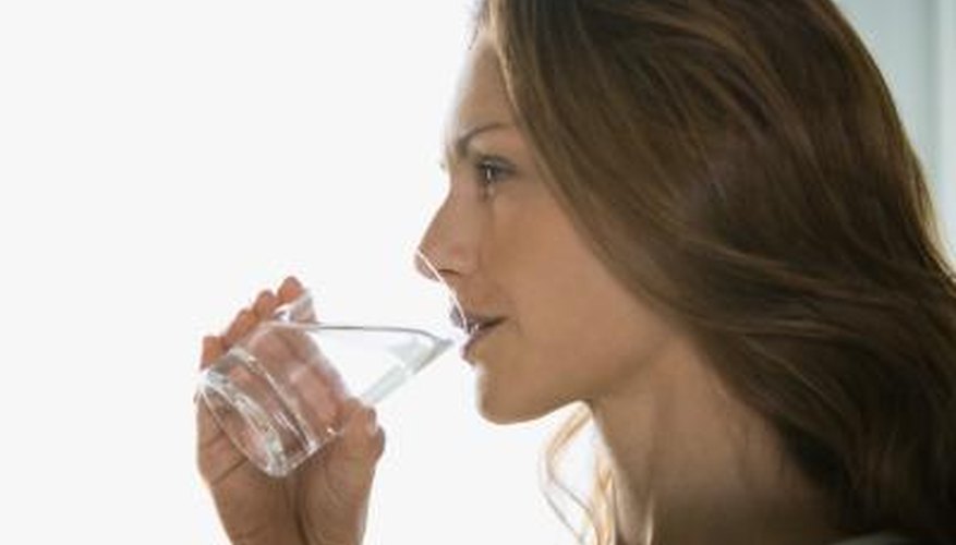 Woman drinking a glass of water. Woman drinking a glass of water.