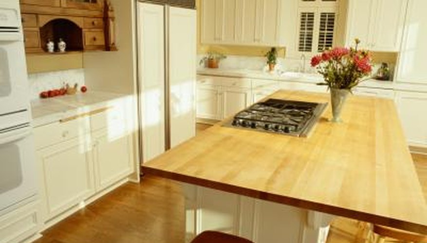 Cabinets have been painted white in a modern kitchen. Cabinets have been painted white in a modern kitchen.