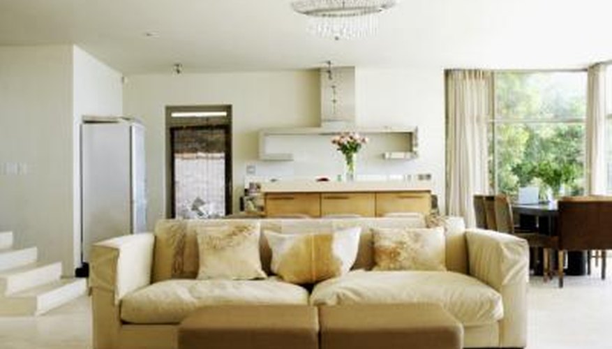 A couch is placed in the center of a room. A couch is placed in the center of a room.