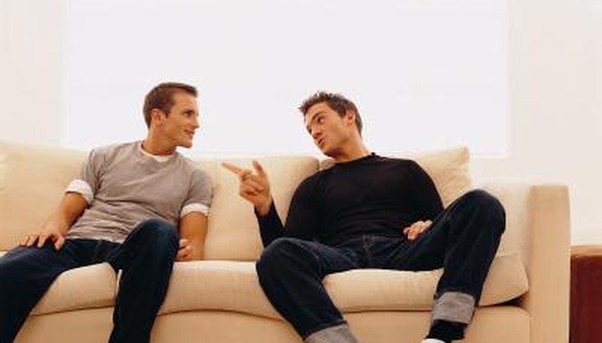 Two friends talk on couch Two friends talk on couch