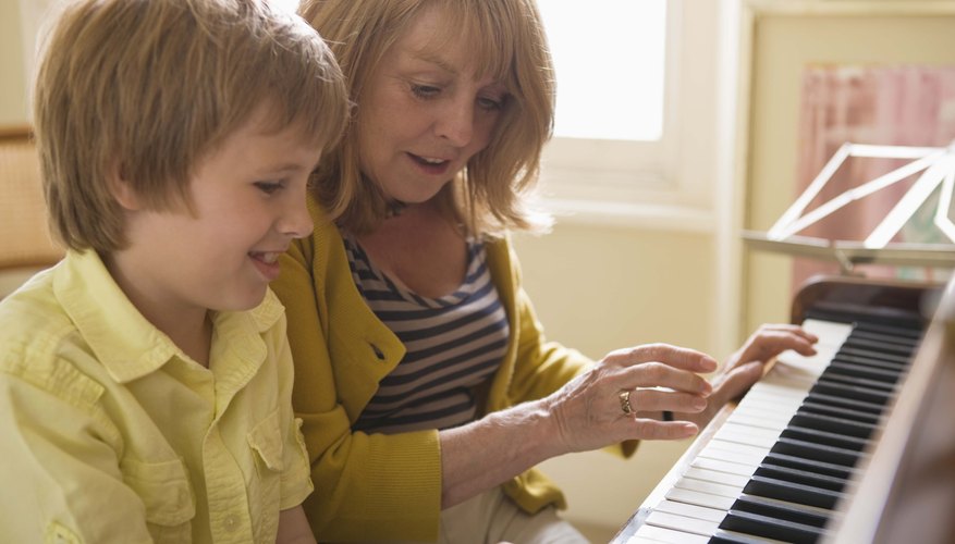 Woman playing piano with grandson