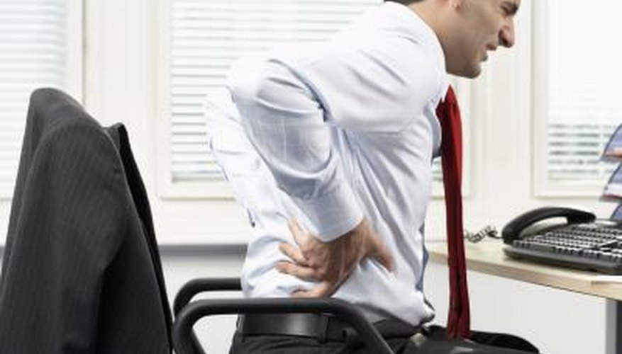 Sitting for long hours in a desk chair, especially one with poor back support, can cause lower back pain.