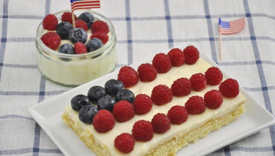 A mini cheesecake and shortbread are topped with blueberries and raspberries fit for the occasion A mini cheesecake and shortbread are topped with blueberries and raspberries fit for the occasion