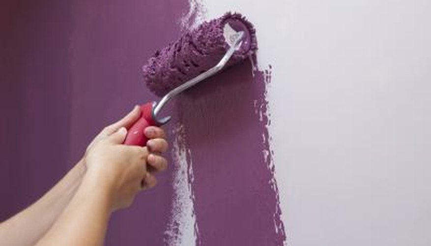 woman painting interior of house woman painting interior of house
