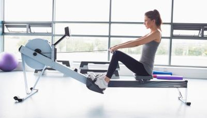 A woman is using a rowing machine at the gym. A woman is using a rowing machine at the gym.