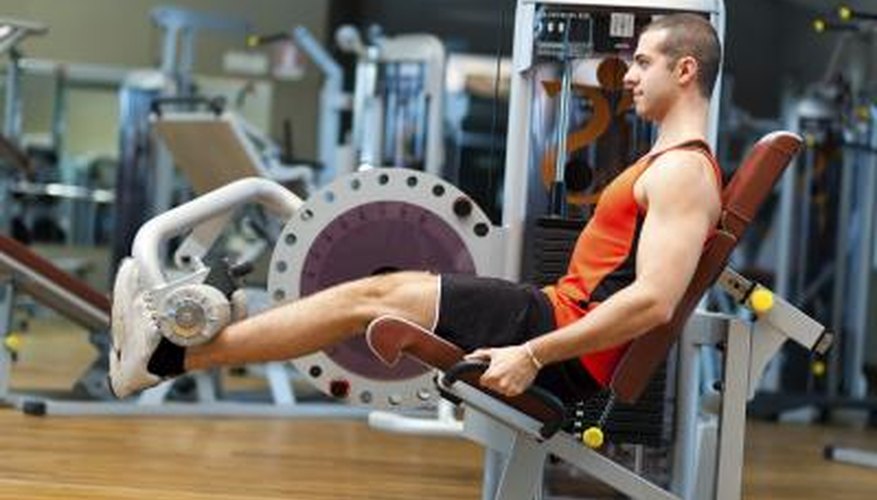A man sitting in a machine at the gym to target the soleus. A man sitting in a machine at the gym to target the soleus.