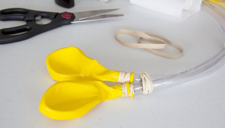 Secure single balloons on the end of each plastic tubing.