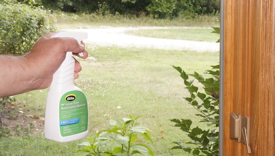 Clean the window again with film application solution. Clean the window again with film application solution.