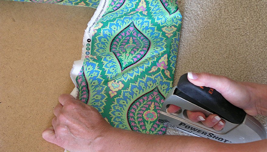Tack the fabric in place on each of the four sides. Tack the fabric in place on each of the four sides.
