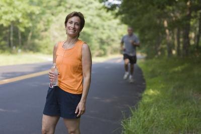 Woman going on exercise walk on side of the road.